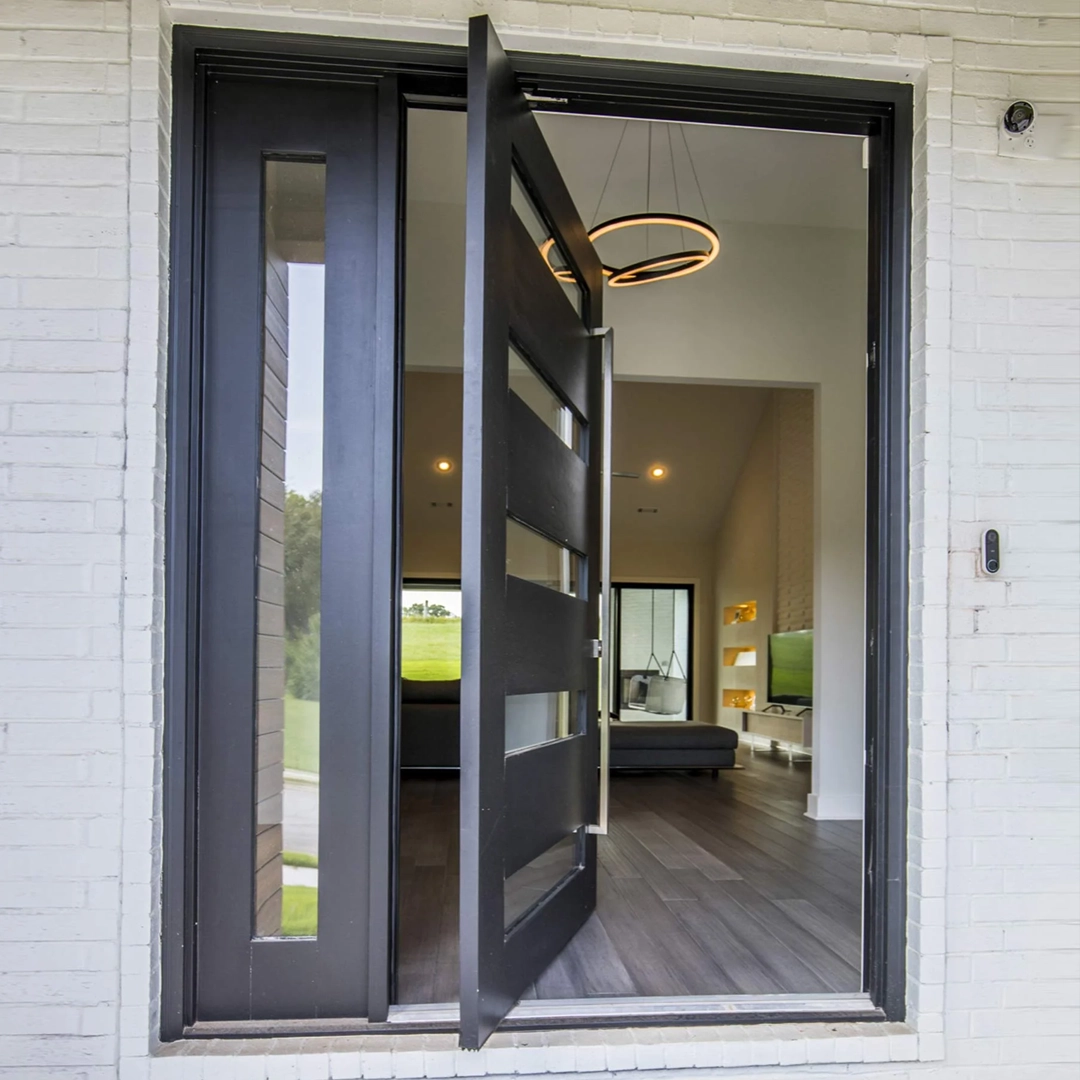 Large impact pivot door integrated into a modern architectural entrance